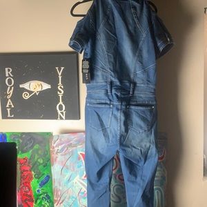 A jumpsuit ,onesie ,with zipper , and a belt loop